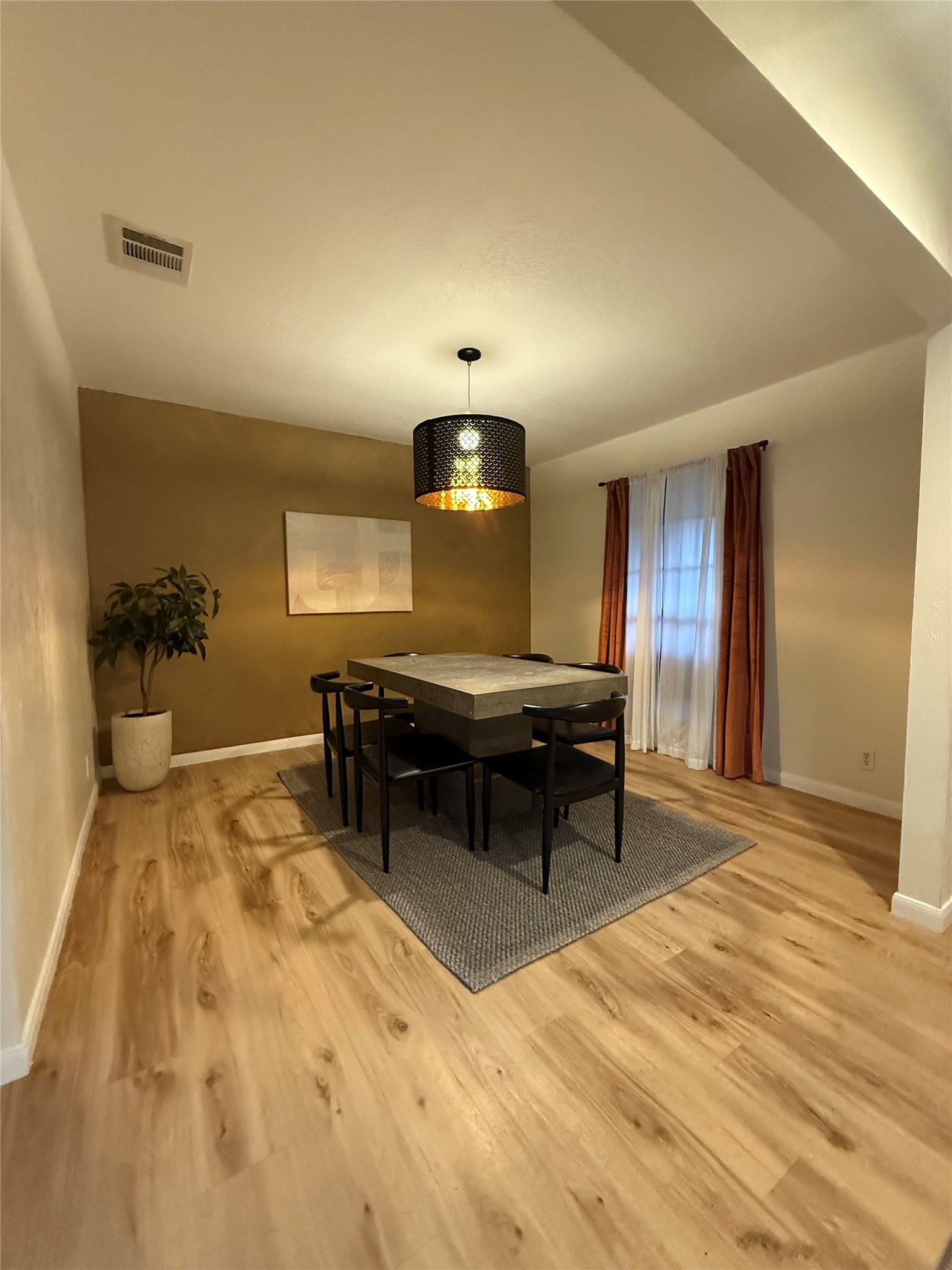 9507 Sherbrooke Street Austin, TX 78729 - Photo 5 of 29 a living room with a table chairs and a wooden floor