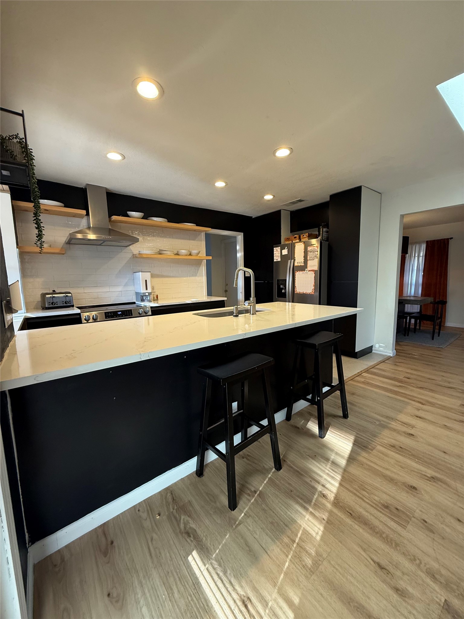 9507 Sherbrooke Street Austin, TX 78729 - Photo 9 of 29 a kitchen with a table chairs and wooden floor