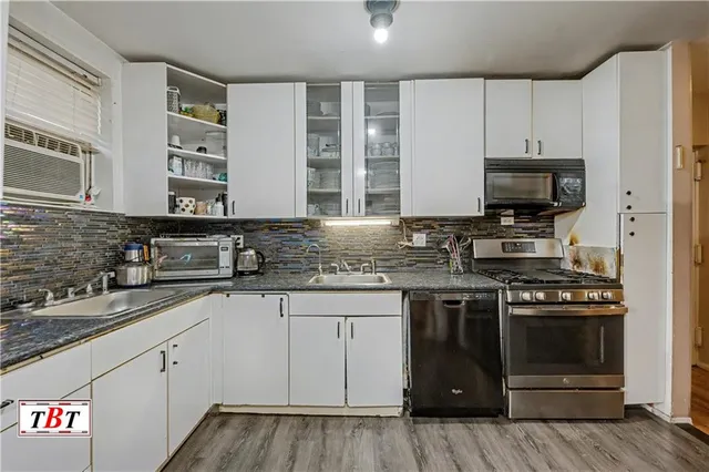 a kitchen with granite countertop a stove and a sink
