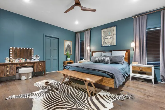 a bedroom with a bed mirror and window