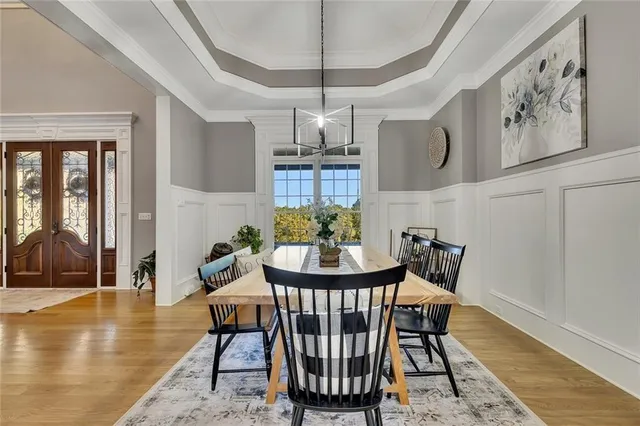 a kitchen with stainless steel appliances granite countertop a sink a stove a refrigerator and island with wooden floor