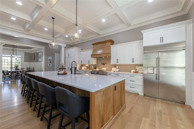 a bedroom with a large bed a flat screen tv and a couch