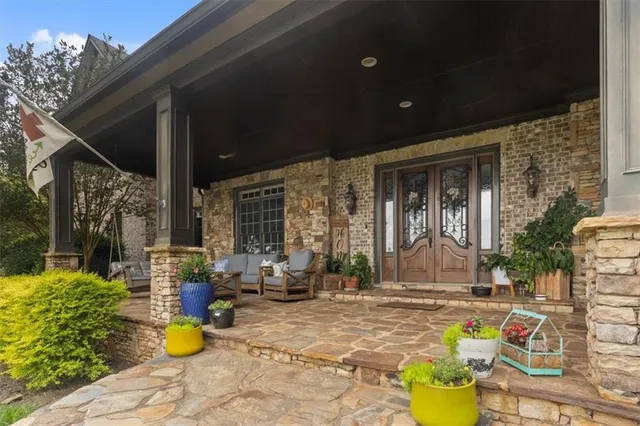 a roof deck with chairs and wooden floor