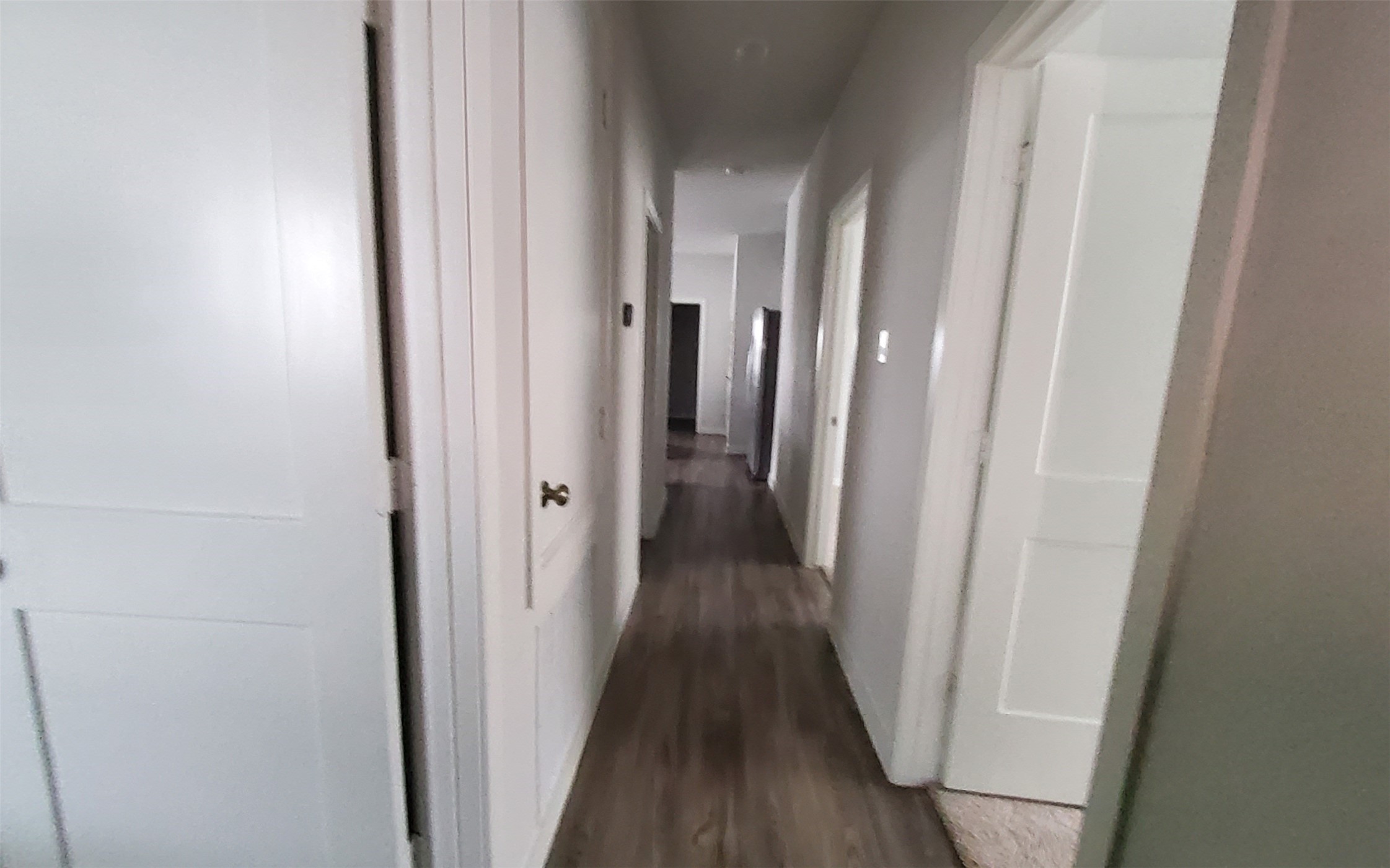 17359 King Eider Road Waller, TX 77484 - Photo 11 of 22 a view of a hallway with wooden floor