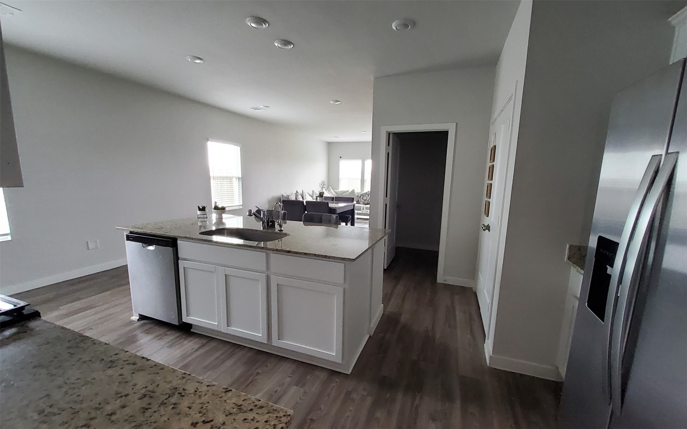 17359 King Eider Road Waller, TX 77484 - Photo 9 of 22 a kitchen with stainless steel appliances granite countertop a refrigerator a sink a stove and white cabinets