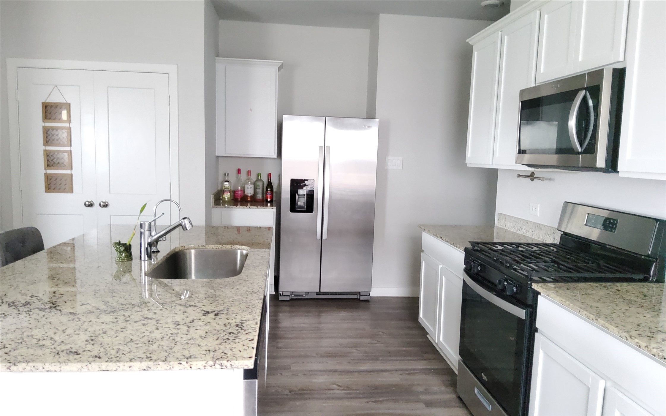 17359 King Eider Road Waller, TX 77484 - Photo 10 of 22 a kitchen with stainless steel appliances granite countertop a sink stove and refrigerator