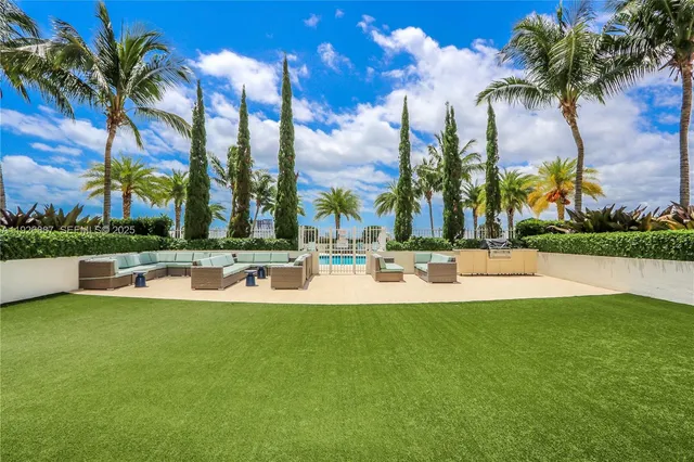 a view of a swimming pool and tall trees