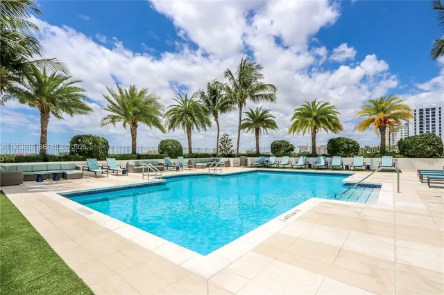a view of outdoor space with swimming pool and lounge chair