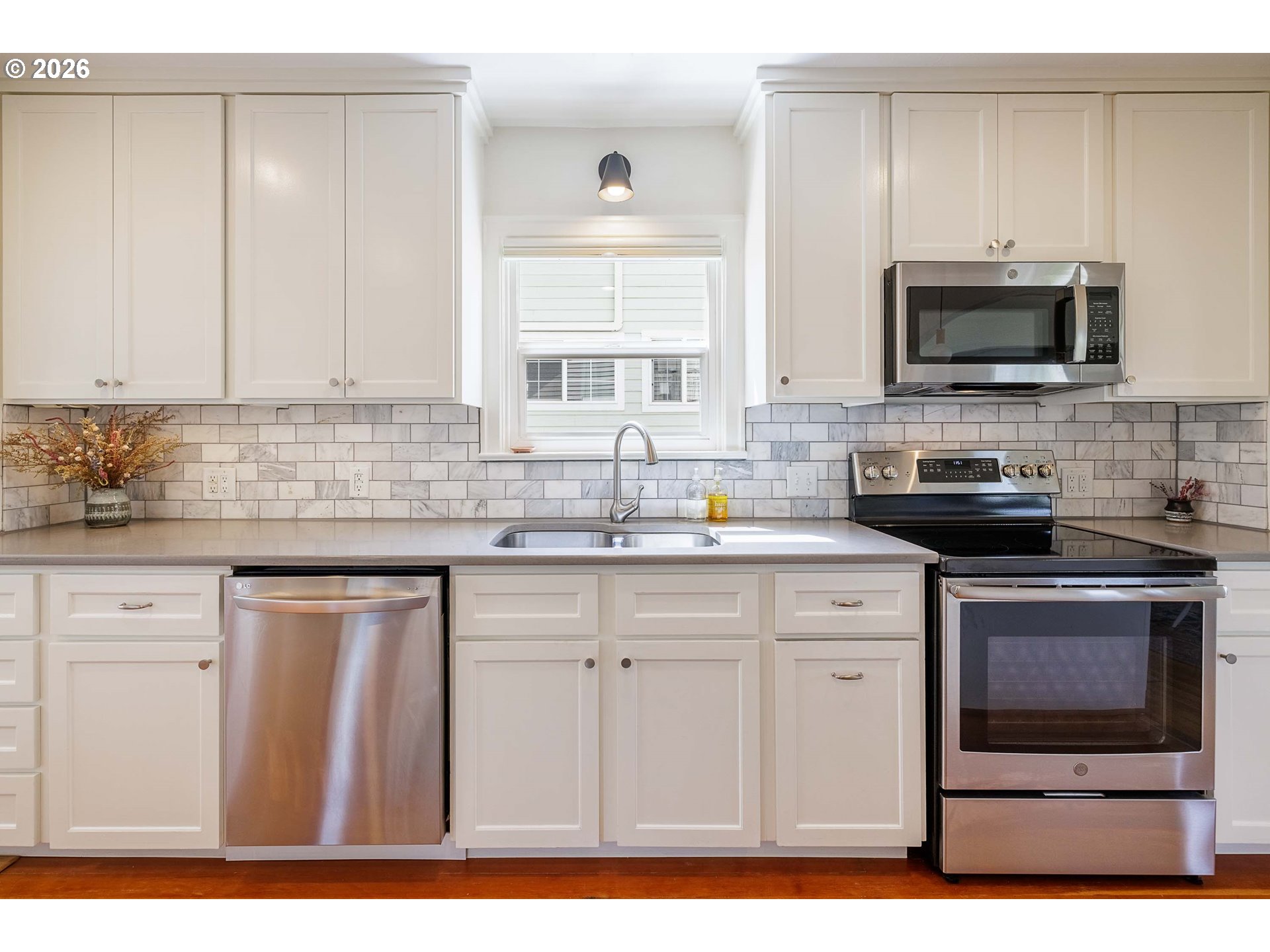 6128 North Denver Avenue Portland, OR 97217 - Photo 12 of 32 a kitchen with stainless steel appliances granite countertop a sink a stove and microwave