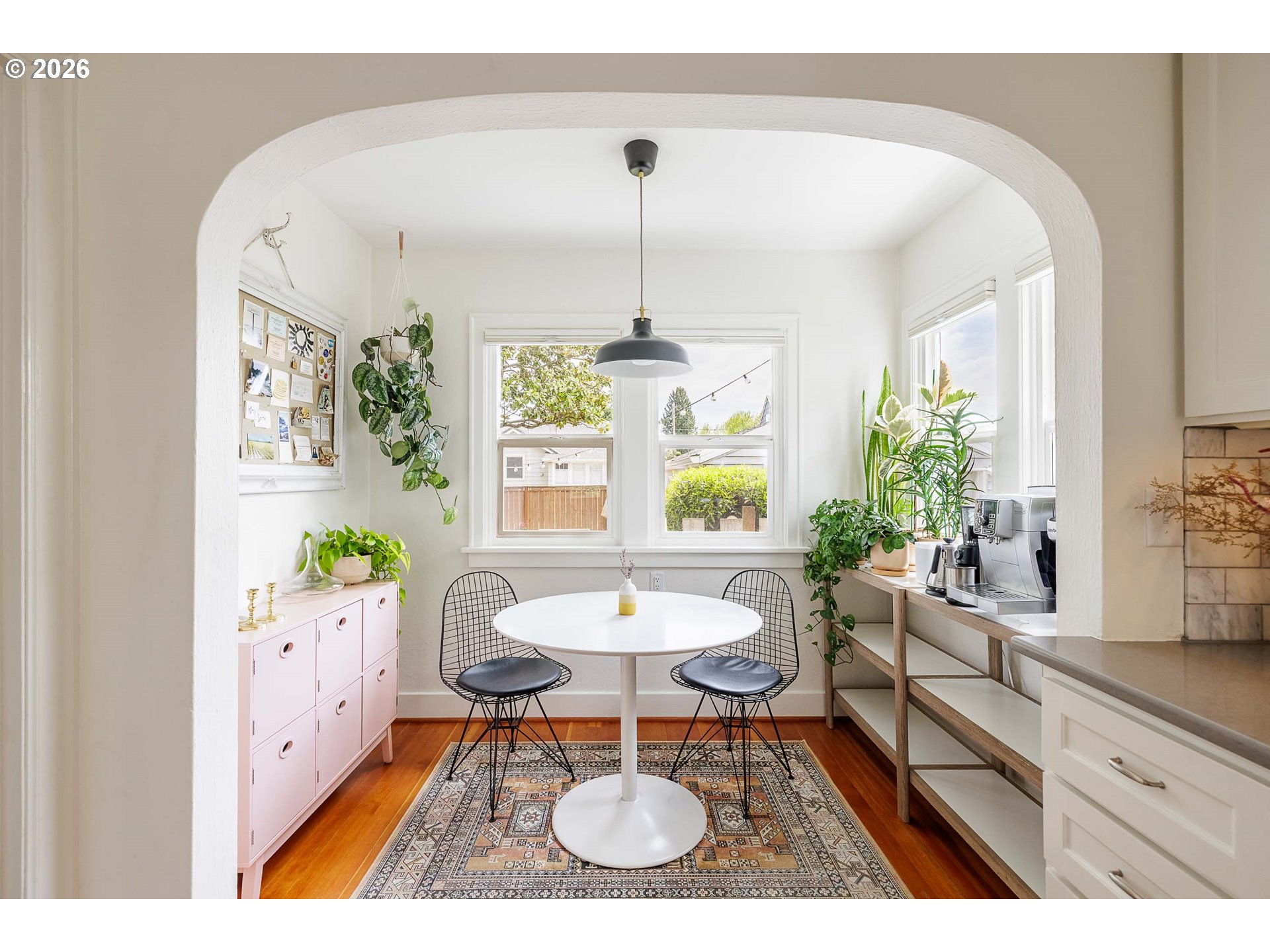 6128 North Denver Avenue Portland, OR 97217 - Photo 13 of 32 a dining room with furniture a rug and a chandelier