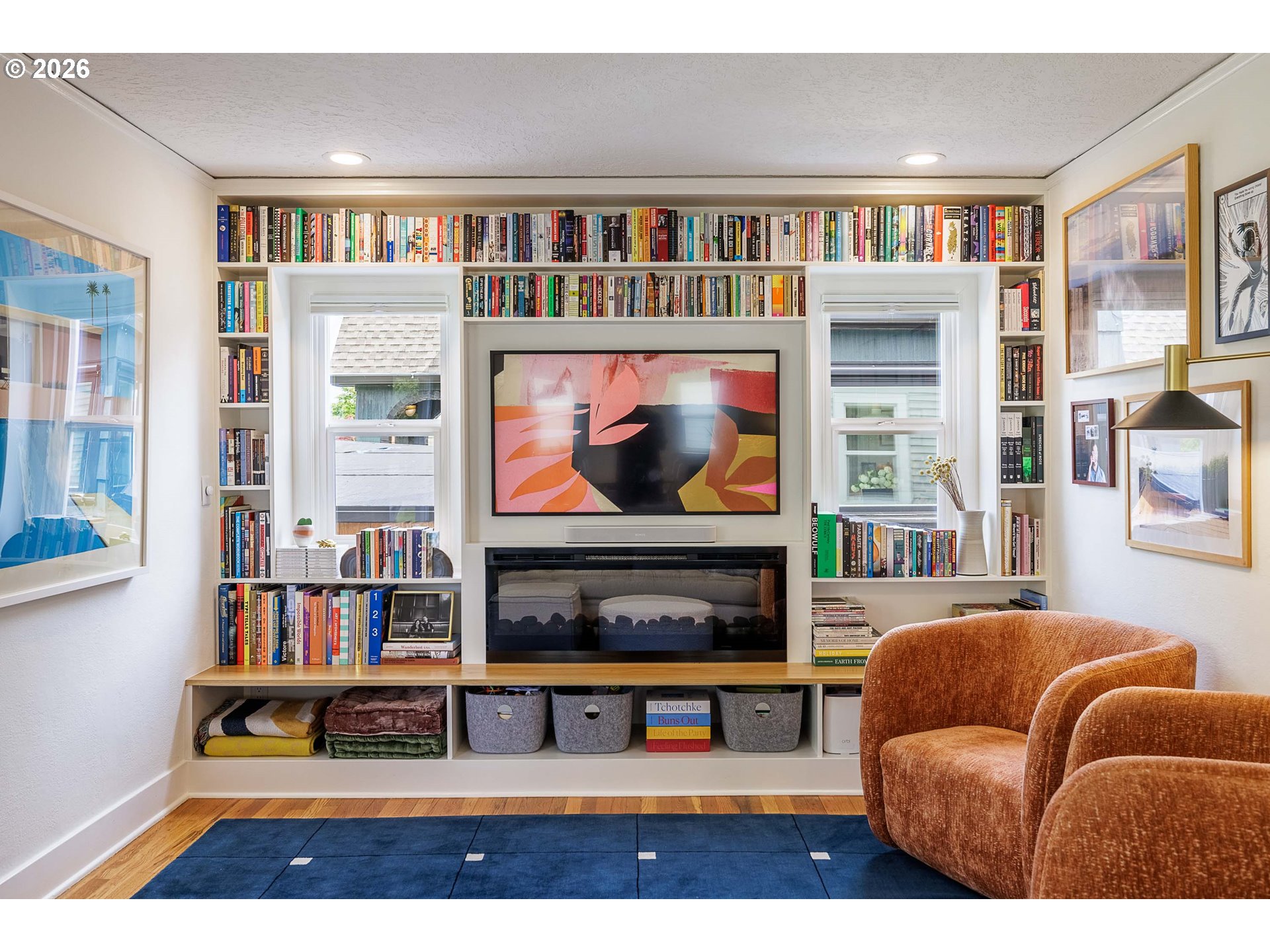 6128 North Denver Avenue Portland, OR 97217 - Photo 4 of 32 a living room with furniture a bookshelf and a fireplace
