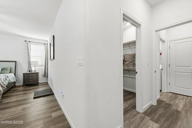 a view of a bedroom with wooden floor and bedroom