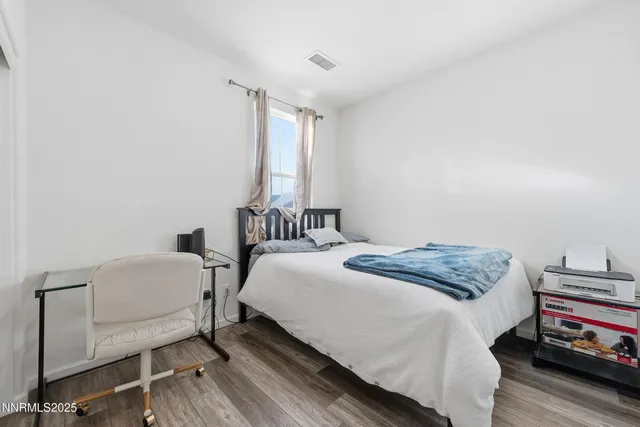 a bedroom with a bed and a chair