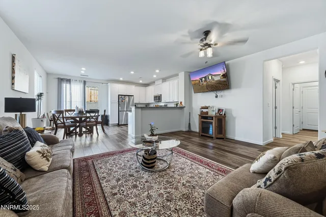 a living room with furniture and kitchen view