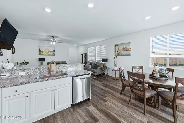 a living room with furniture a wooden floor and a sink