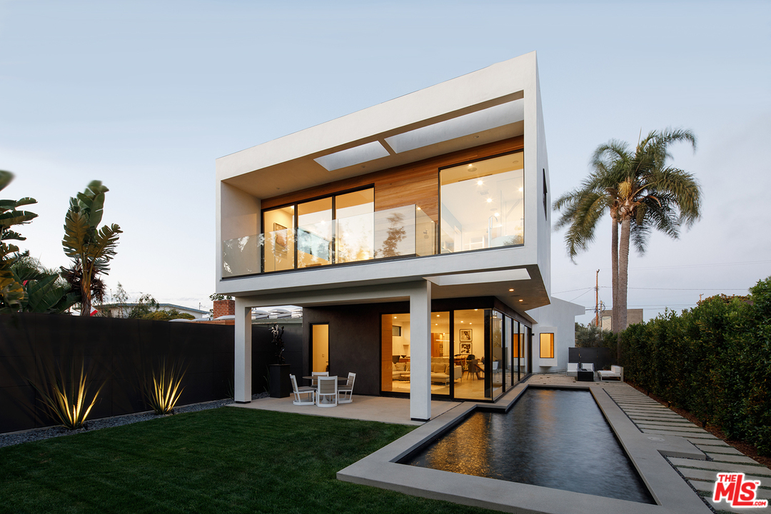 a view of a house with a swimming pool and a porch with furniture