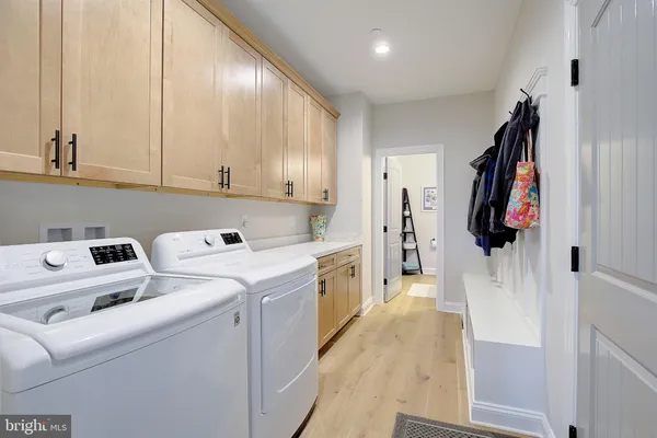 a view of storage and utility room with washer and dryer