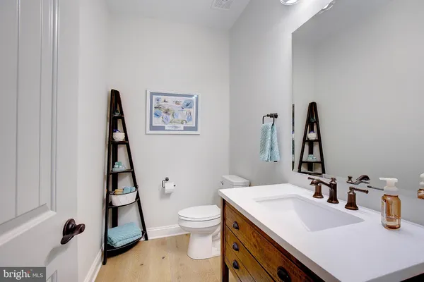 a bathroom with a sink vanity and toilet