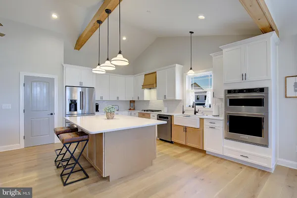 a kitchen with a stove a refrigerator and a sink