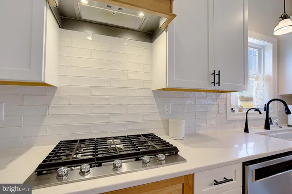 a close view of a stove a sink and dishwasher in a kitchen