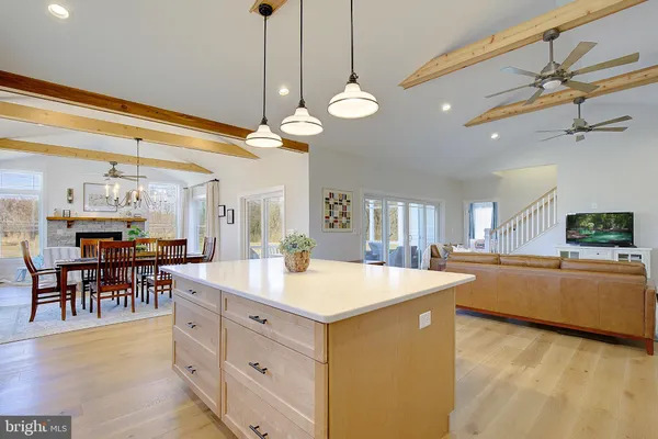 a large kitchen with a table and chairs