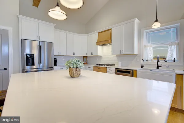 a large white kitchen with cabinets