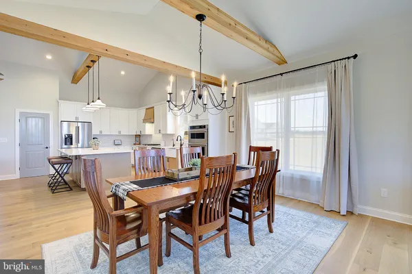 a view of a dining room with furniture and a chandelier