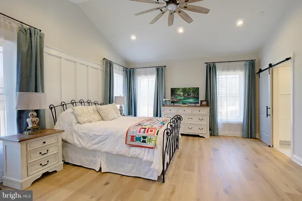 a bedroom with furniture and a chandelier