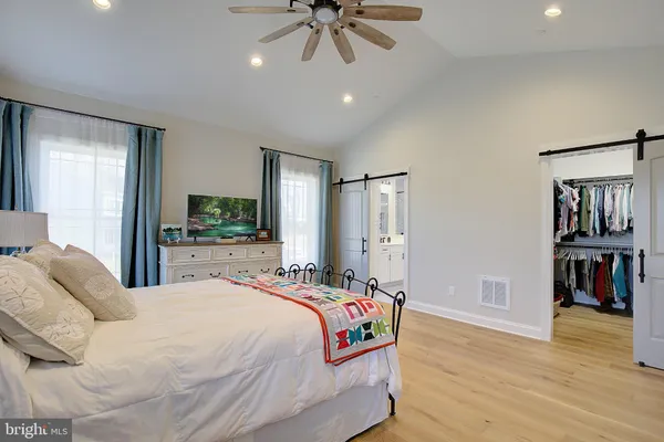 a bedroom with a bed and a chandelier