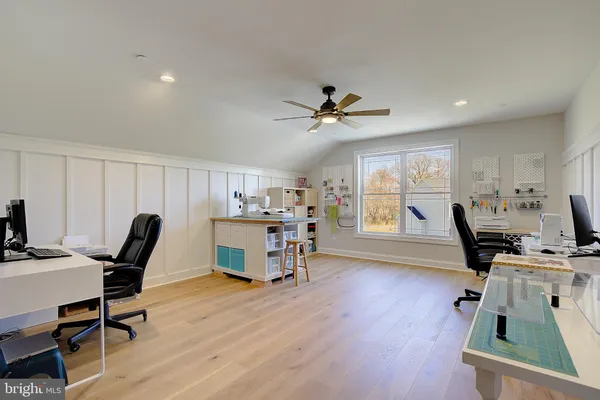 a workspace with wooden floor and a window