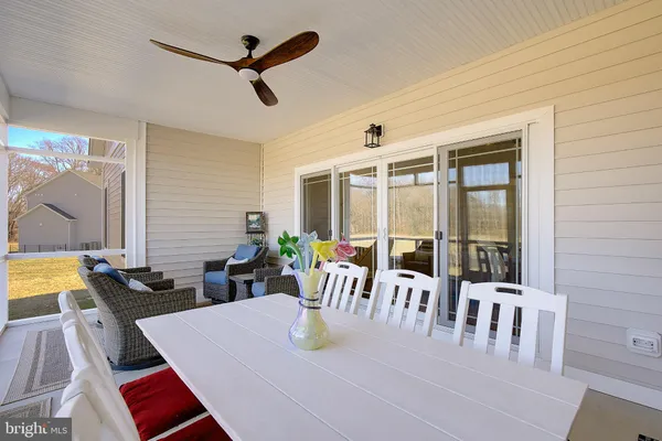 a dining room with furniture a rug and a large window