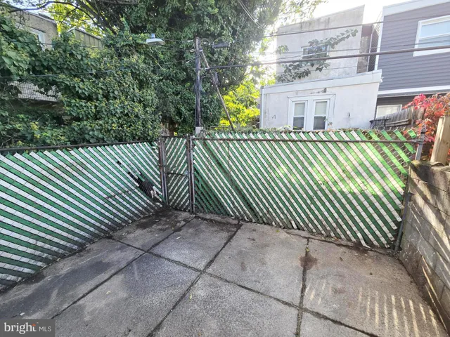 a side view of a house with a street