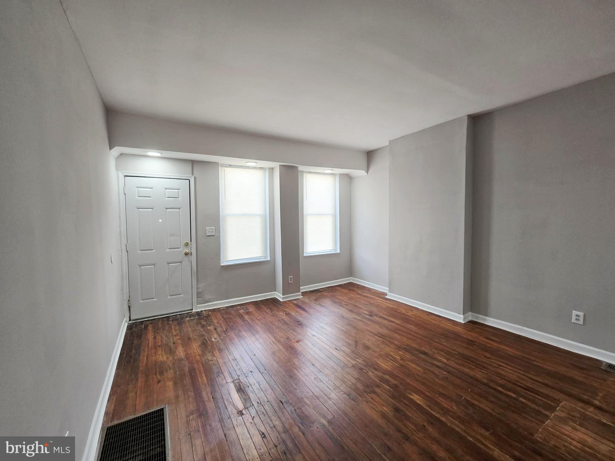 1910 Sigel Street Philadelphia, PA 19145 - Photo 4 of 25 a view of an empty room with wooden floor and window