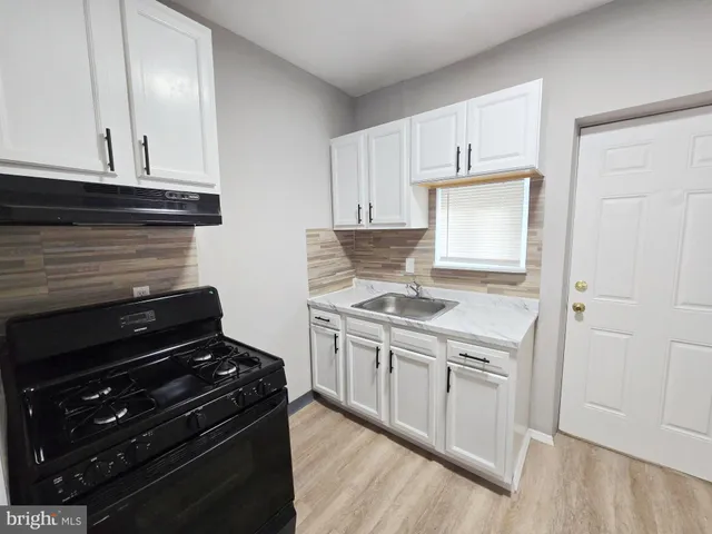 a kitchen with a stove and a microwave