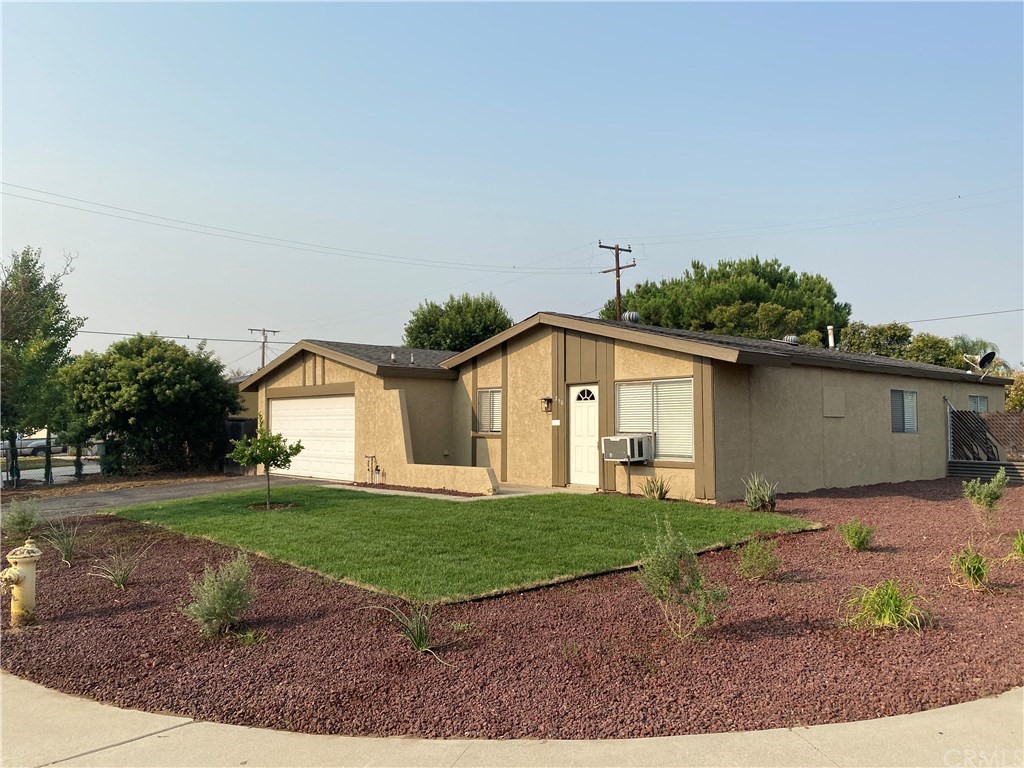 250 South Lamarr Street Rialto, CA 92376 - Photo 1 of 1 a front view of a house with a yard and garage