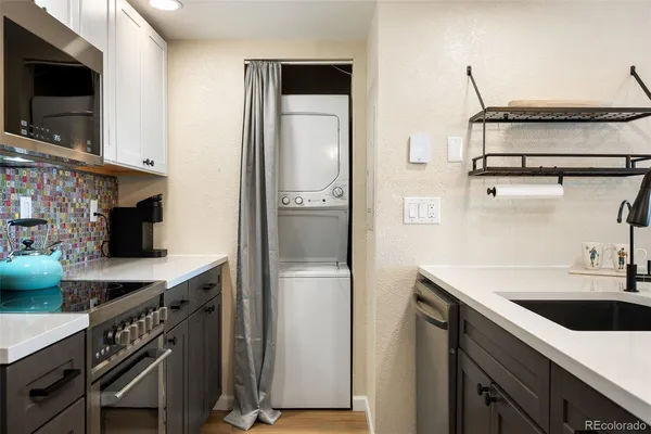 a kitchen with stainless steel appliances a sink a stove and a refrigerator
