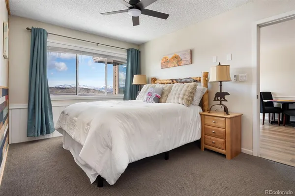 a spacious bedroom with a bed and a large window