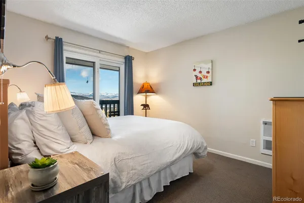 a bedroom with a bed and potted plant