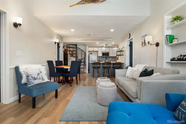 a living room with furniture and a dining table with kitchen view