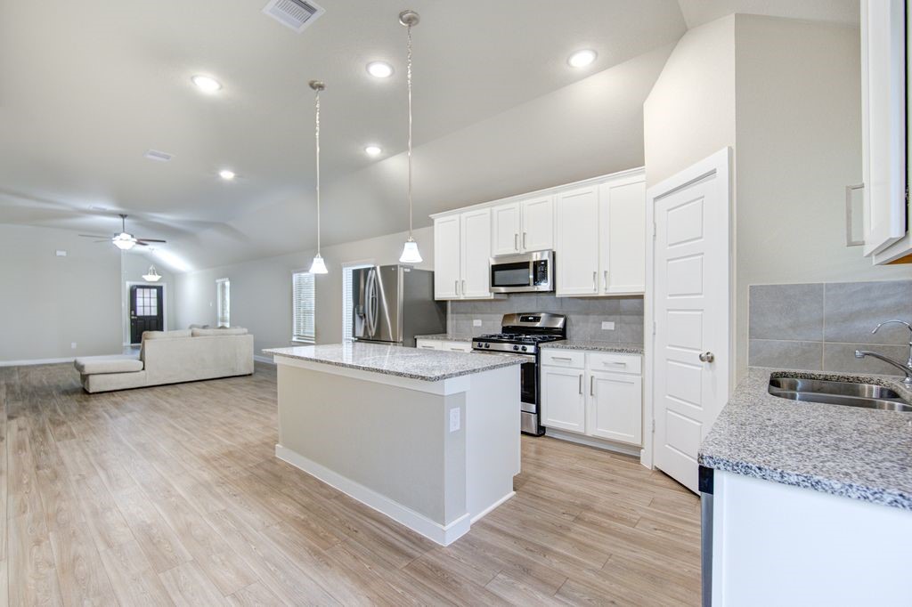17692 Tree Of Heaven Conroe, TX 77385 - Photo 21 of 50 Look at the open space and the long countertop, perfect for breakfast or chatting while food is being prepared.