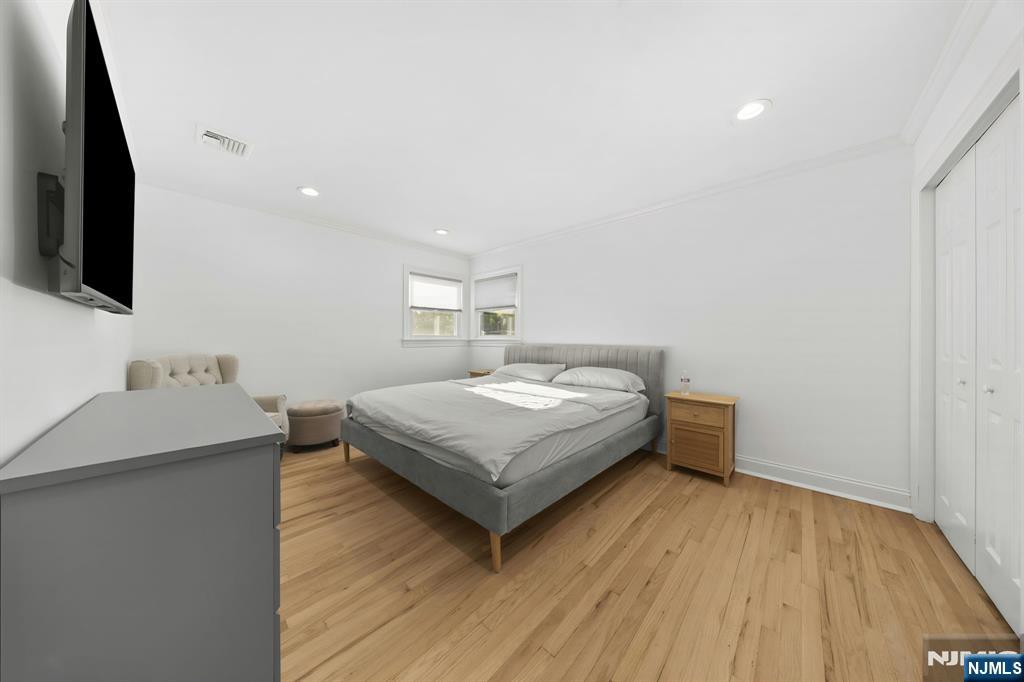 62 Sycamore Road Dumont, NJ 07628 - Photo 17 of 43 a bedroom with a bed and a flat screen tv