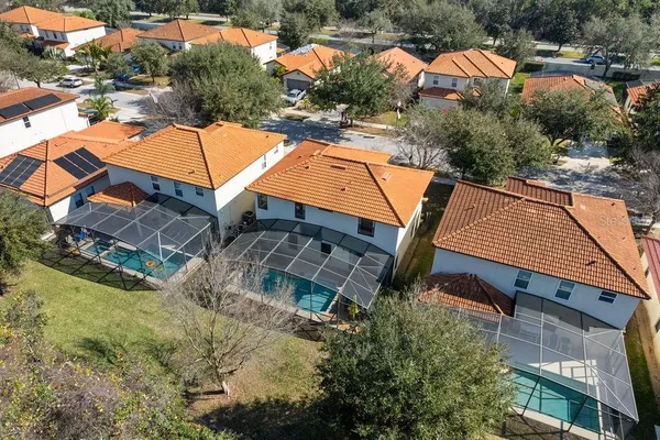 an aerial view of a house with swimming pool and outdoor seating