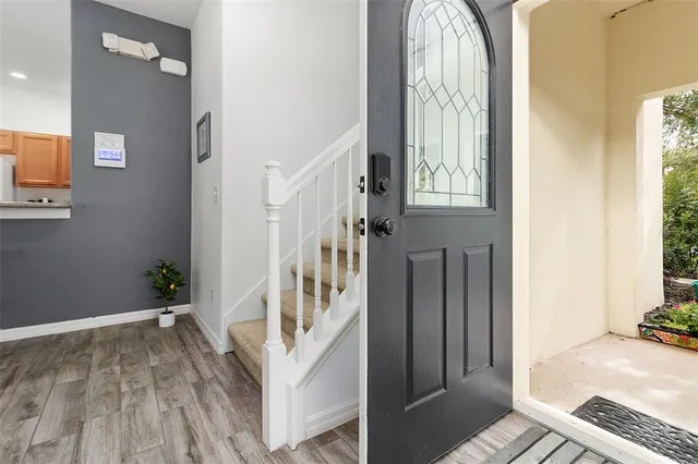 a view of an entryway with wooden floor and windows