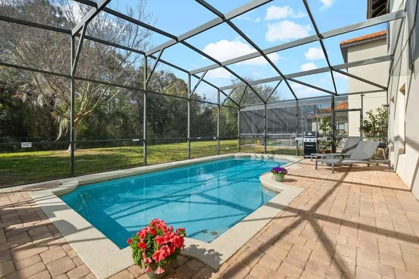 an aerial view of house with yard swimming pool and outdoor seating
