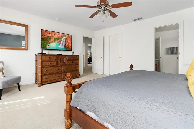 a bathroom with a granite countertop sink a mirror and shower