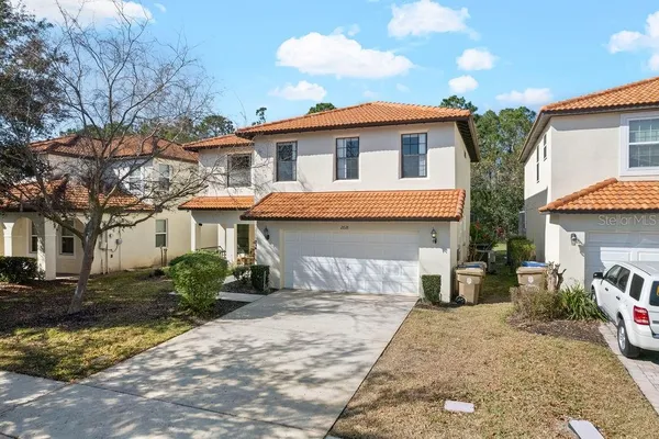 a bedroom with a bed and painting on the wall