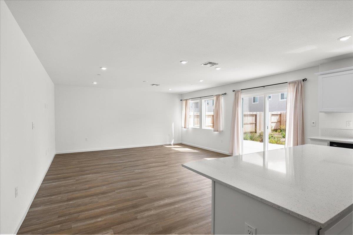 18462 Waterfront Way Lathrop, CA 95330 - Photo 11 of 50 a view of an empty room with wooden floor and a window