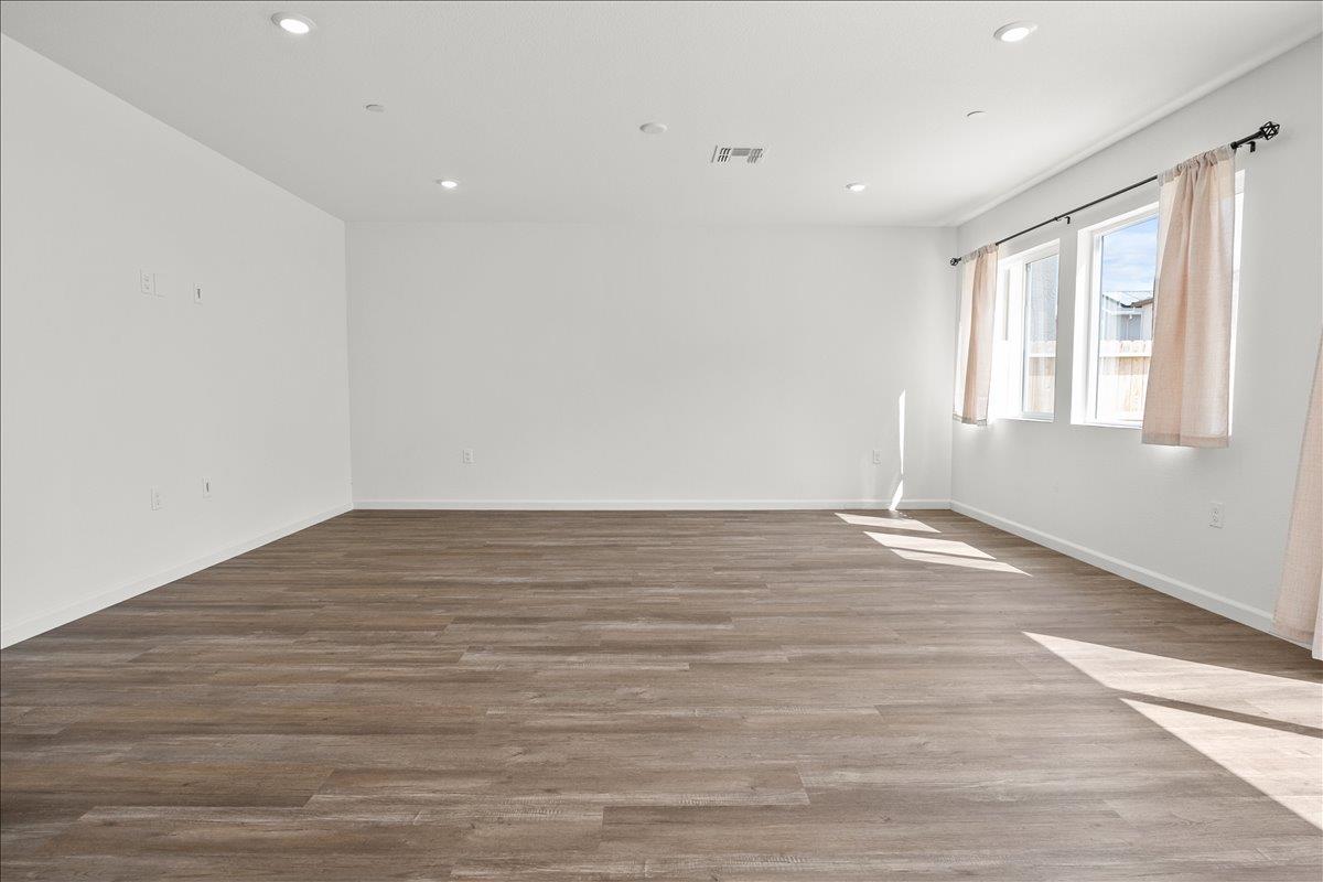 18462 Waterfront Way Lathrop, CA 95330 - Photo 12 of 50 a view of empty room with wooden floor and fan