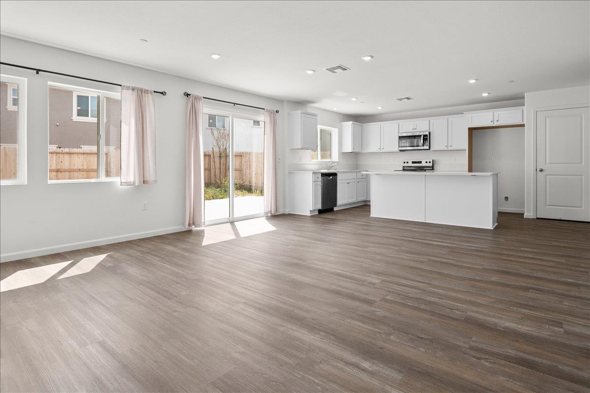 18462 Waterfront Way Lathrop, CA 95330 - Photo 14 of 50 a view of kitchen with cabinets and wooden floor