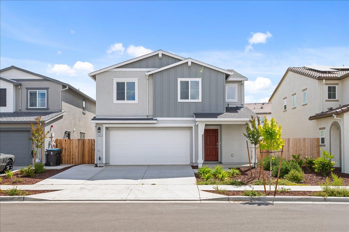 18462 Waterfront Way Lathrop, CA 95330 - Photo 2 of 50 a front view of a house with a yard and garage